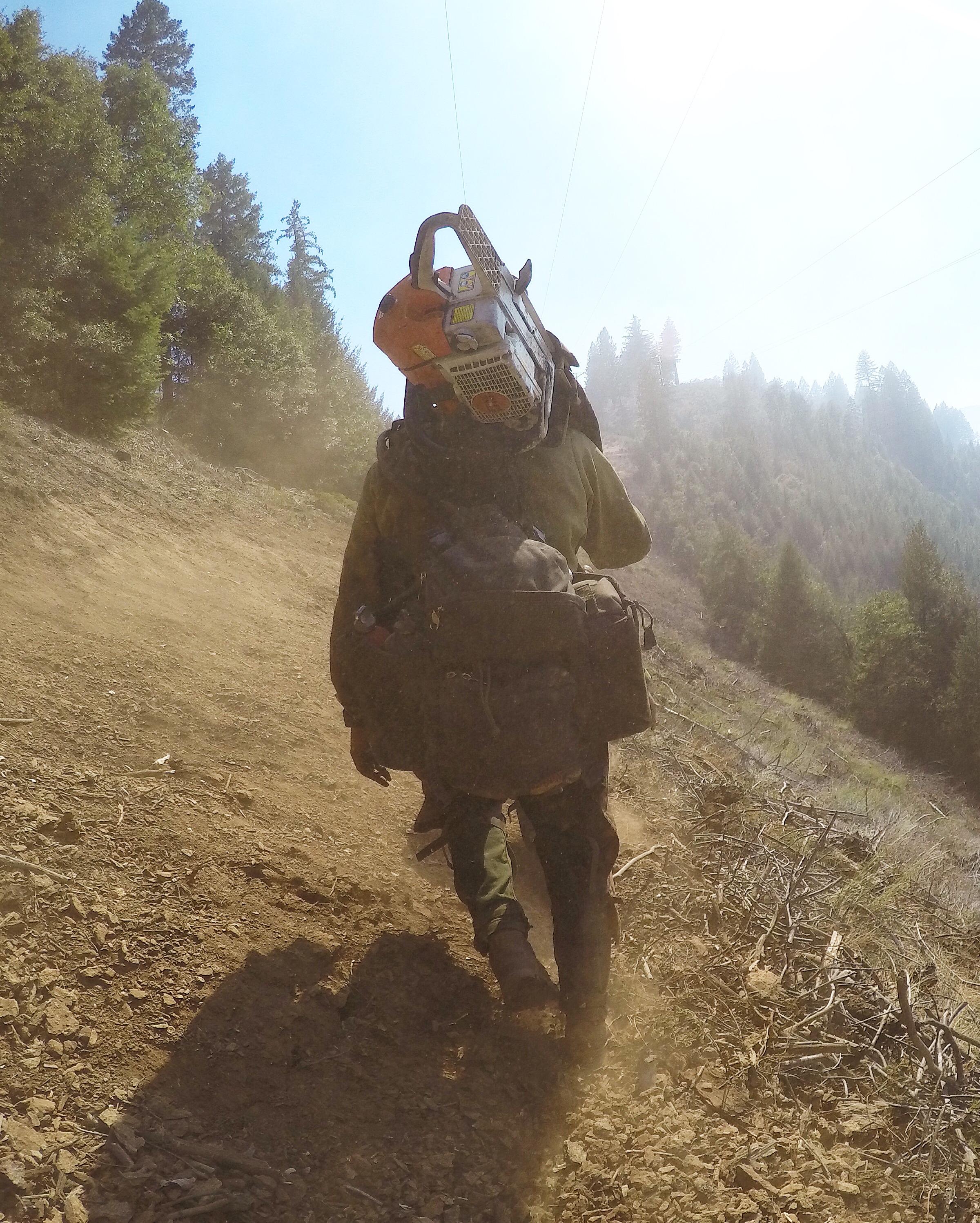 Wildland firefighter carrying chainsaw from taken by ExpertVoice Expert Gregg Boydston