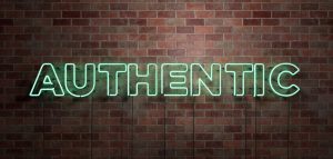 neon green sign displaying "Authentic"