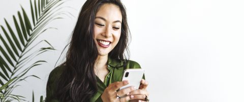 Happy woman using mobile phone